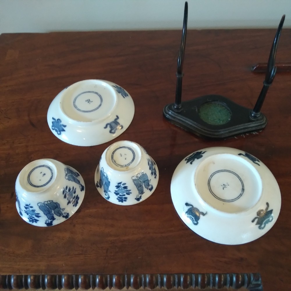 A collection of varied Chinese blue and white and polychrome porcelain vases, bowls, and jars displayed along a dark wood sideboard. View XVII