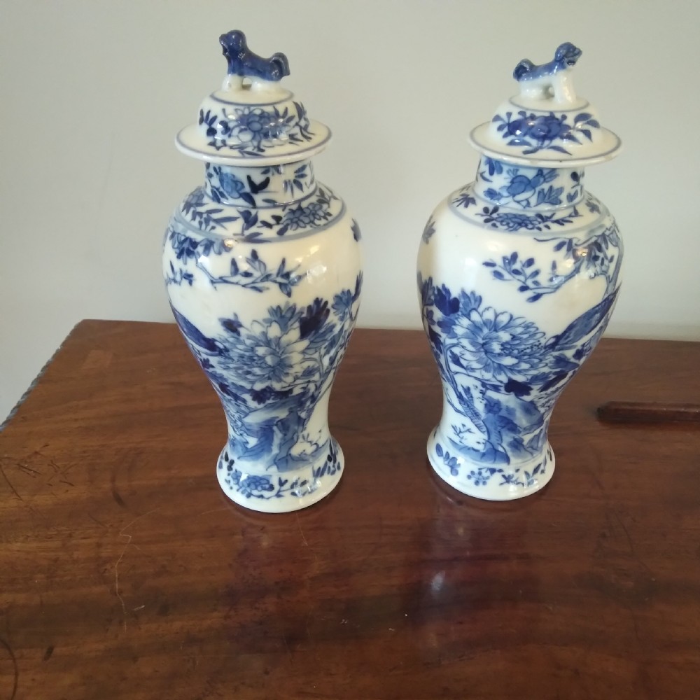 A collection of varied Chinese blue and white and polychrome porcelain vases, bowls, and jars displayed along a dark wood sideboard. View XVIII