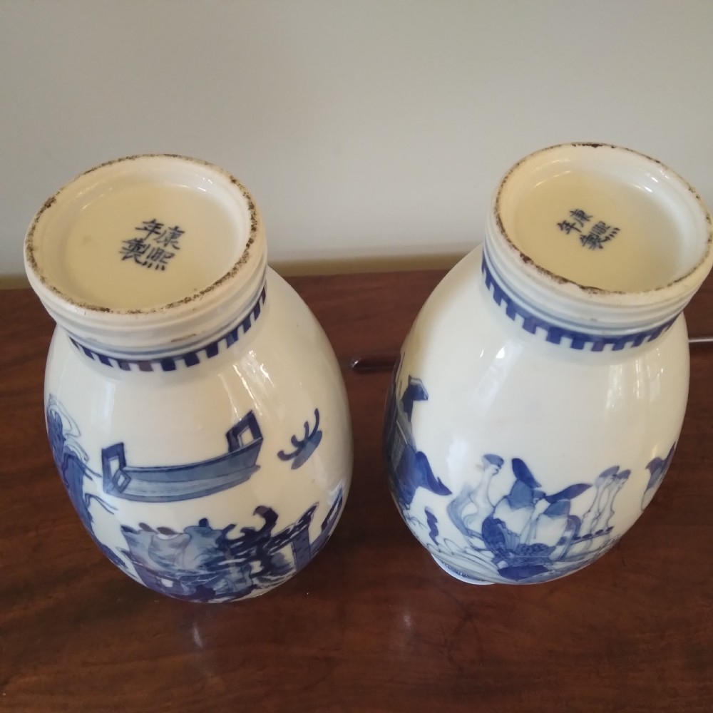 A collection of varied Chinese blue and white and polychrome porcelain vases, bowls, and jars displayed along a dark wood sideboard. View XX
