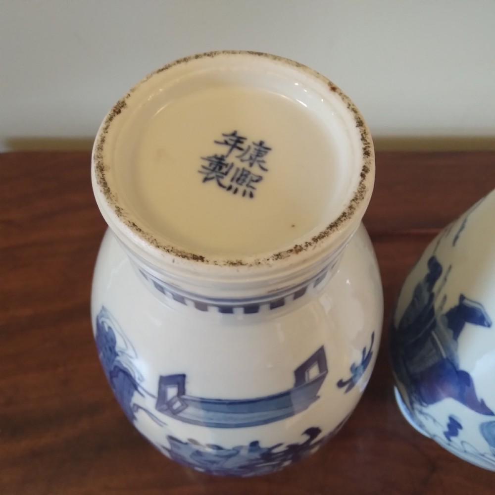 A collection of varied Chinese blue and white and polychrome porcelain vases, bowls, and jars displayed along a dark wood sideboard. View XXI