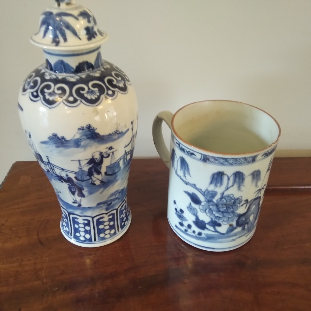 A collection of varied Chinese blue and white and polychrome porcelain vases, bowls, and jars displayed along a dark wood sideboard. View XXIV