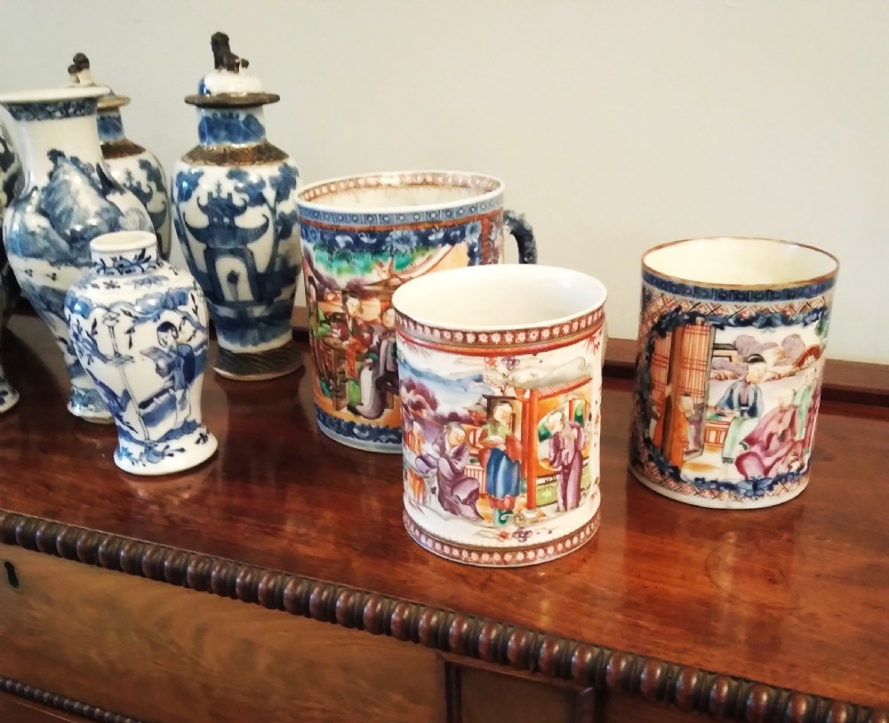 A collection of varied Chinese blue and white and polychrome porcelain vases, bowls, and jars displayed along a dark wood sideboard. View XXVIII