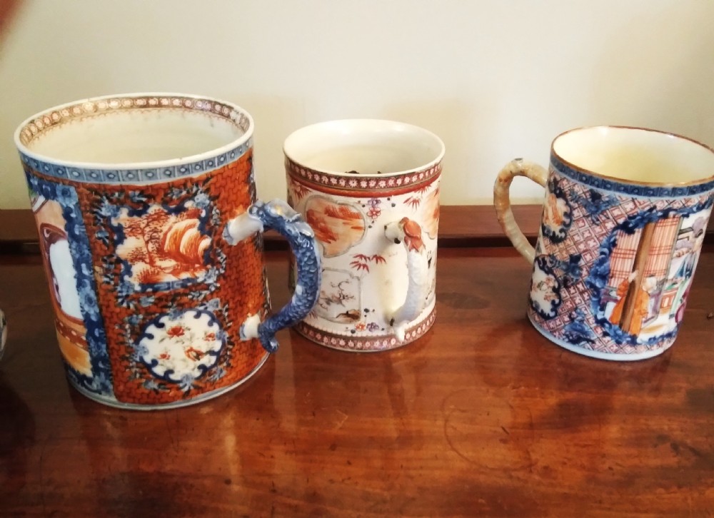 A collection of varied Chinese blue and white and polychrome porcelain vases, bowls, and jars displayed along a dark wood sideboard. View XXX