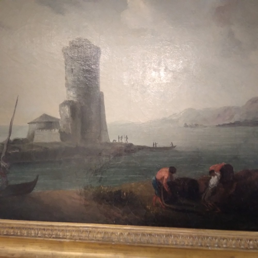 An 18th-century oil painting depicting a coastal seascape with a stone tower, figures, and small boats within a gilded wooden frame. View III