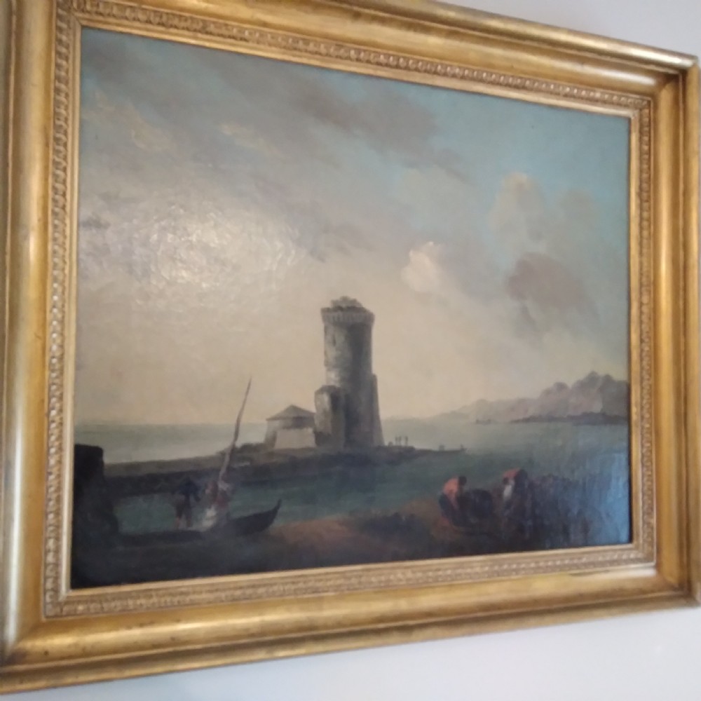 An 18th-century oil painting depicting a coastal seascape with a stone tower, figures, and small boats within a gilded wooden frame. View IV