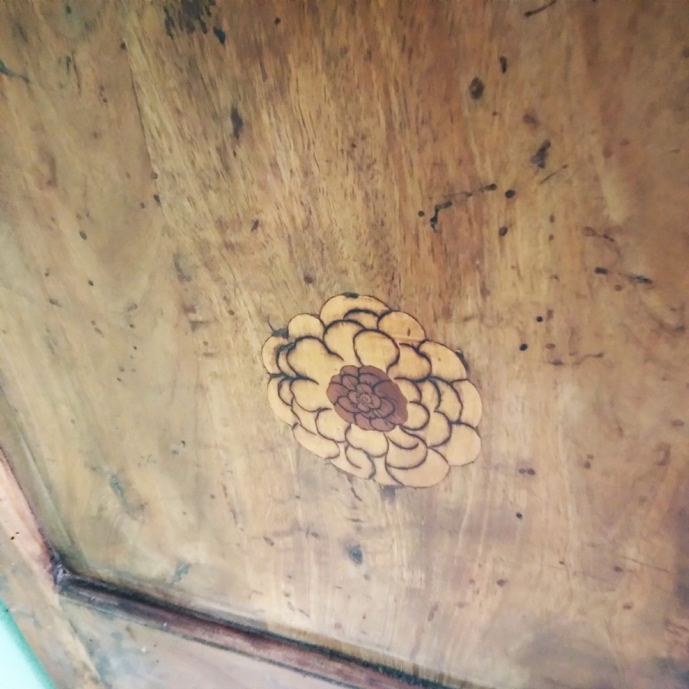 An 18th-century fruitwood writing bureau featuring a sloping fall-front lid with decorative marquetry garland inlays and two drawers below. View VII