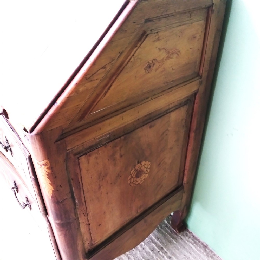 An 18th-century fruitwood writing bureau featuring a sloping fall-front lid with decorative marquetry garland inlays and two drawers below. View XI