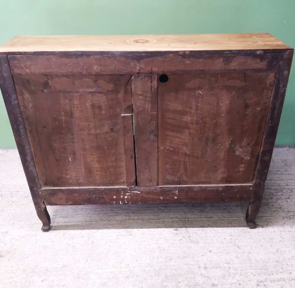 An 18th-century fruitwood writing bureau featuring a sloping fall-front lid with decorative marquetry garland inlays and two drawers below. View XIX