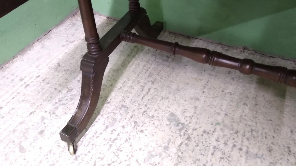 A George III mahogany drop-leaf sofa table featuring decorative border string inlay, two front drawers, a turned stretcher, and splayed legs fitted with brass castors. View VI