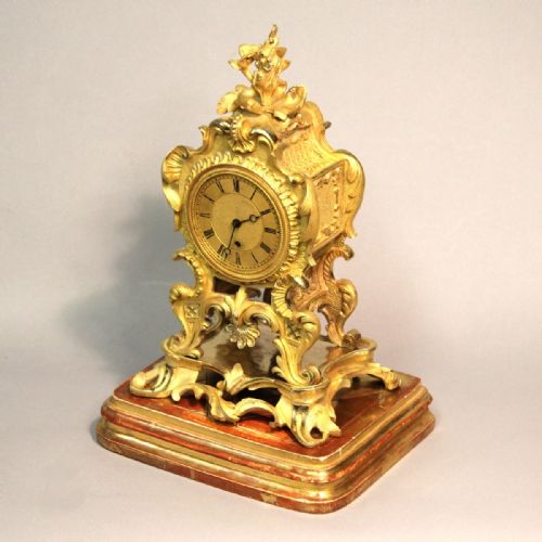 AN ENGLISH ROCOCO STYLE MANTEL CLOCK WITH FUSEE MOVEMENT AND AN ORMOLU CASE BY JOHN PETERKIN CIRCA 1820 - ADDITIONAL PHOTO 1