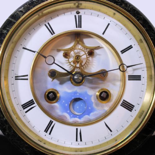 fig 1. A late nineteenth-century French garniture clock set crafted from black slate and green marble with a moon phase dial and two matching side pedestals.
