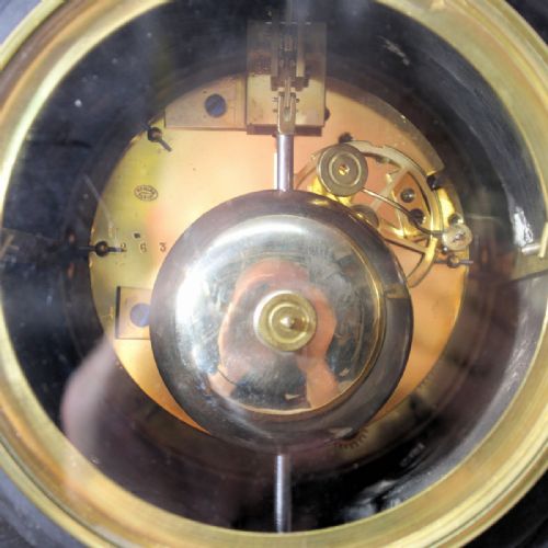 fig 2. A late nineteenth-century French garniture clock set crafted from black slate and green marble with a moon phase dial and two matching side pedestals.