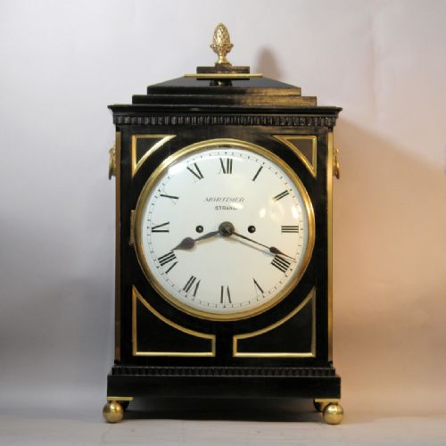 A REGENCY PERIOD ENGLISH CHAMFER TOP BRACKET CLOCK IN AN EBONISED CASE CIRCA 1820 - ADDITIONAL PHOTO 1