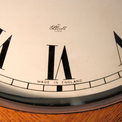 fig 2. A circular twentieth-century oak wall dial clock with black Roman numerals on a cream face, inscribed Fattorini Bradford.