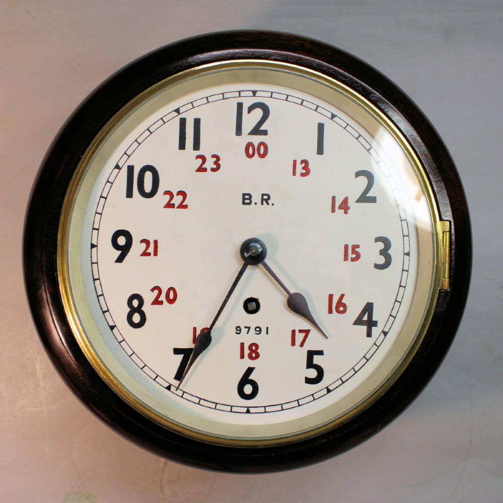 A round Victorian mahogany fusee wall clock featuring an eight-inch white dial with black and red numbers and a brass bezel.