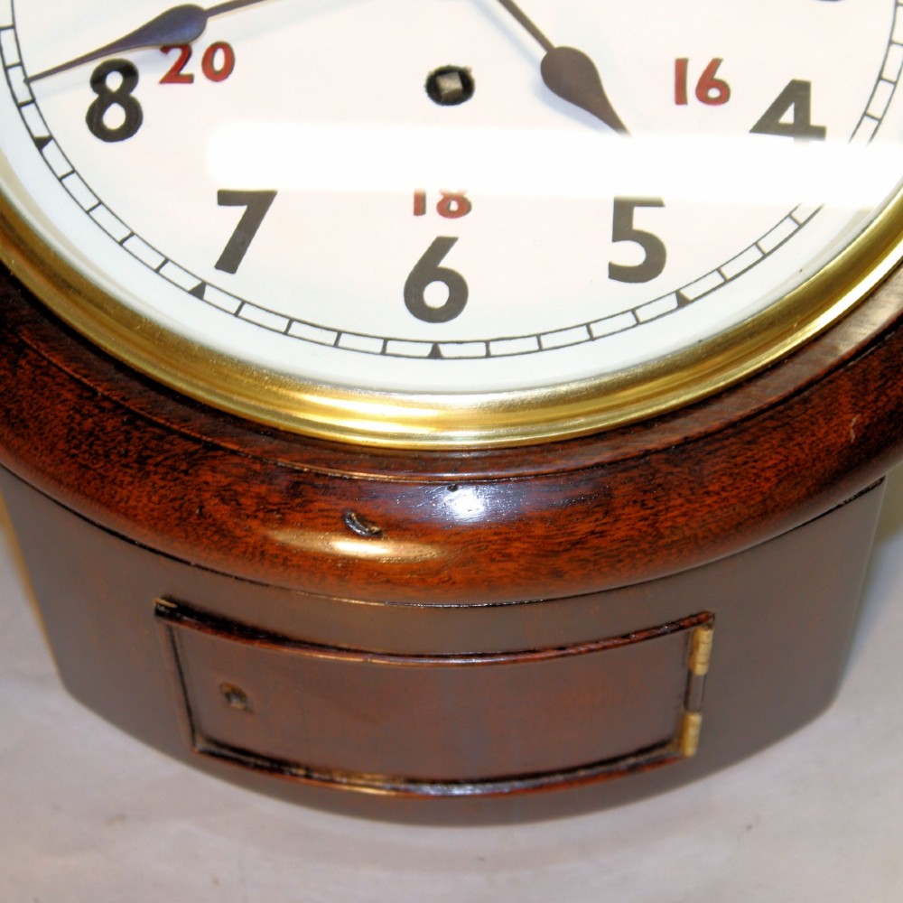 A round Victorian mahogany fusee wall clock featuring an eight-inch white dial with black and red numbers and a brass bezel. View IV