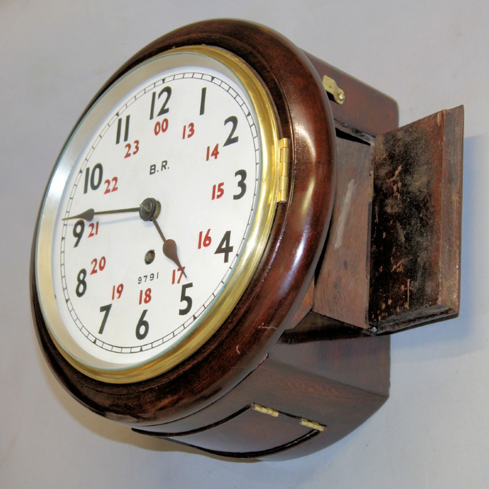 A round Victorian mahogany fusee wall clock featuring an eight-inch white dial with black and red numbers and a brass bezel. View V
