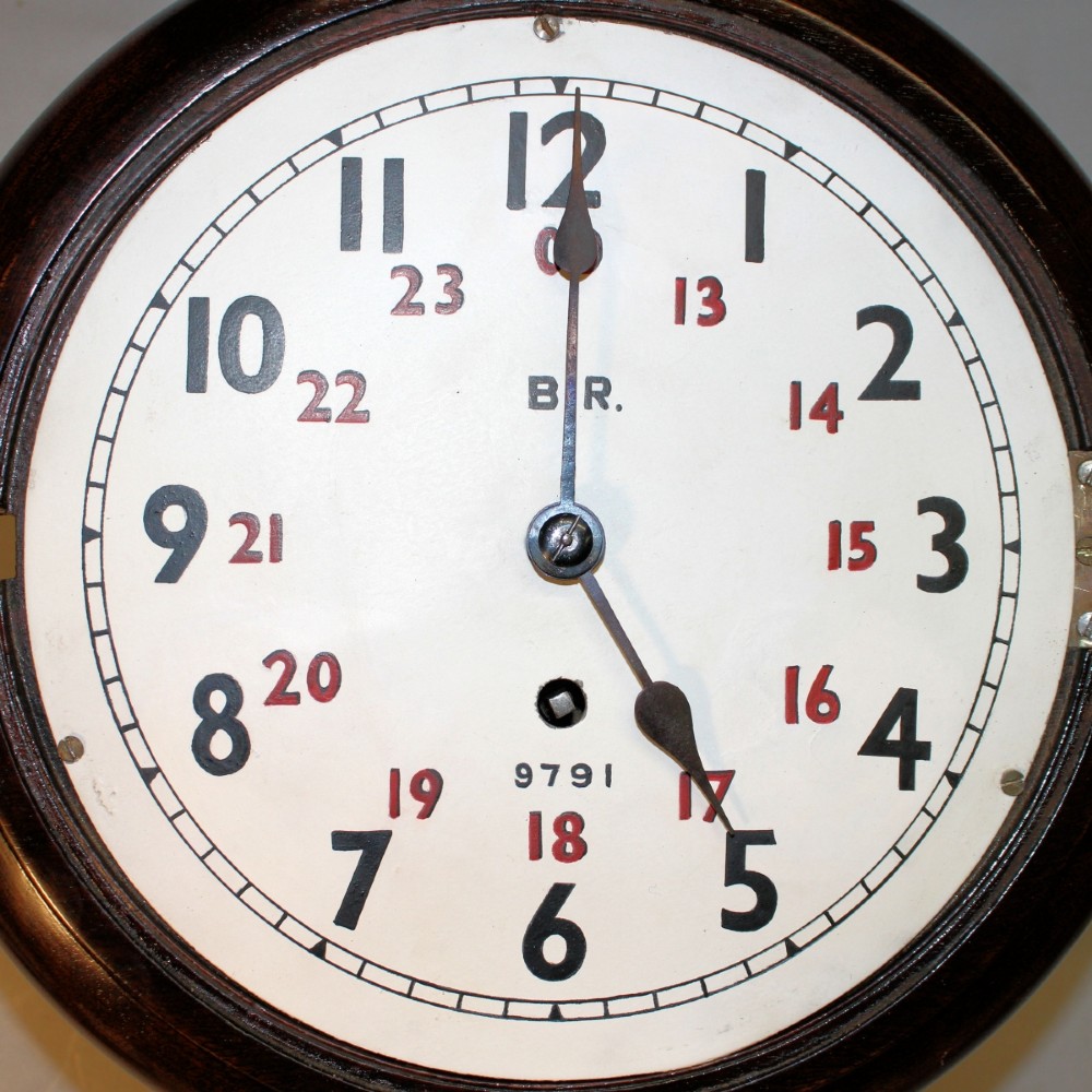 A round Victorian mahogany fusee wall clock featuring an eight-inch white dial with black and red numbers and a brass bezel. View VII
