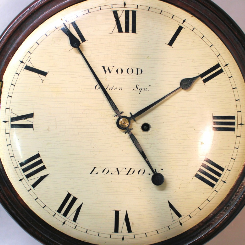 An antique Regency single fusee wall clock featuring an off-white convex wooden dial with Roman numerals, brass bezel, and a dark polished mahogany surround. View IV