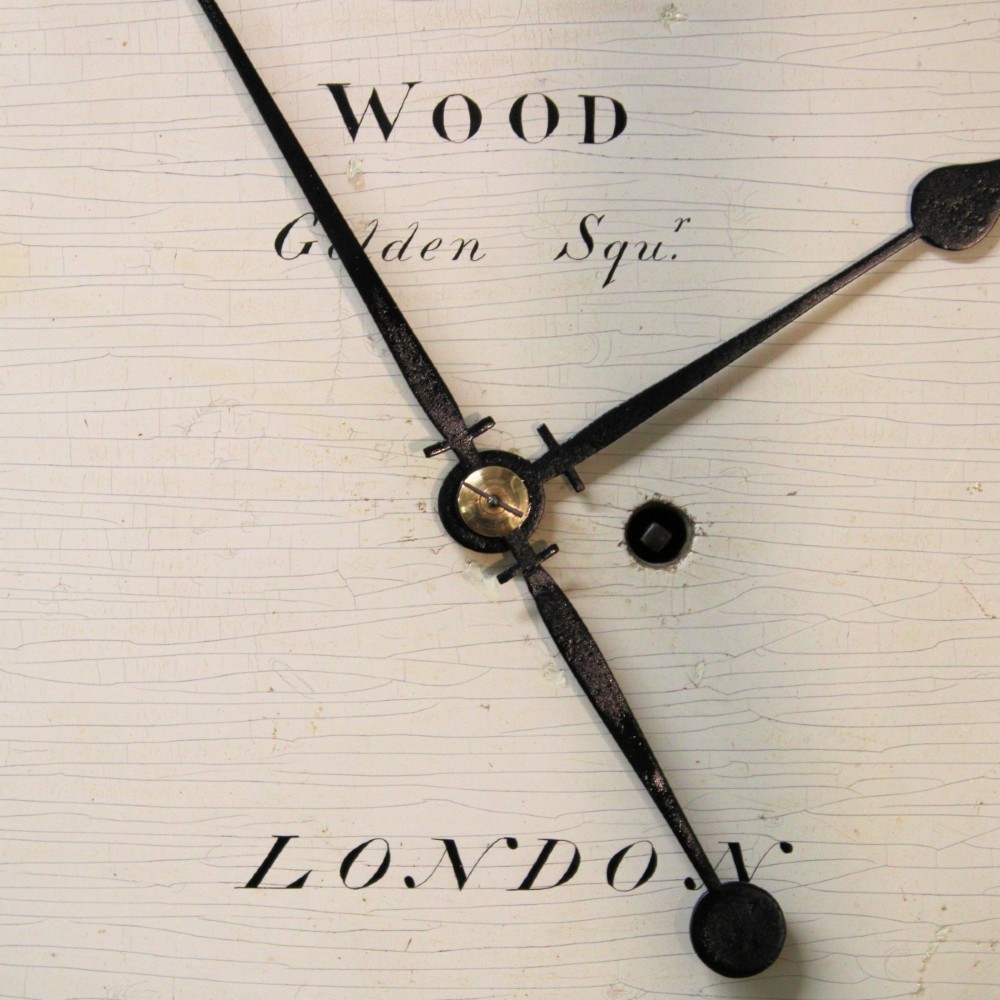 An antique Regency single fusee wall clock featuring an off-white convex wooden dial with Roman numerals, brass bezel, and a dark polished mahogany surround. View X
