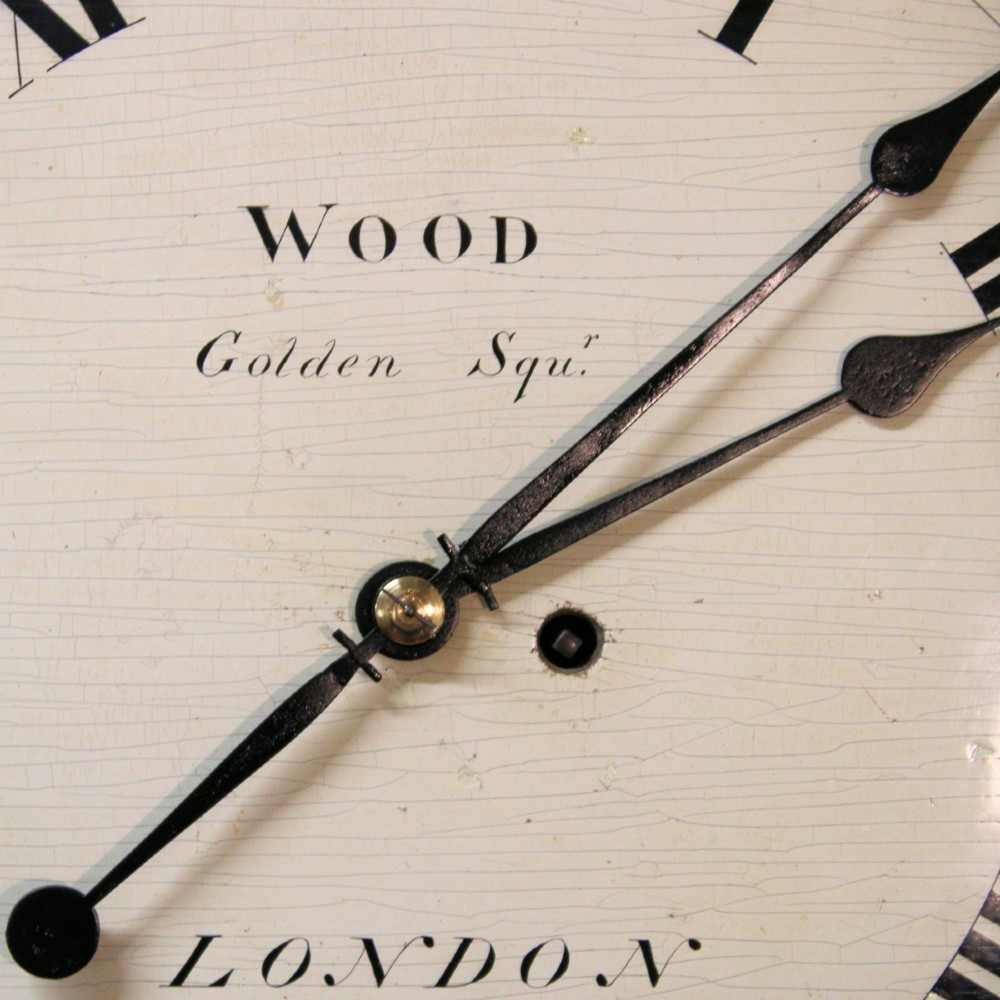 An antique Regency single fusee wall clock featuring an off-white convex wooden dial with Roman numerals, brass bezel, and a dark polished mahogany surround. View XII