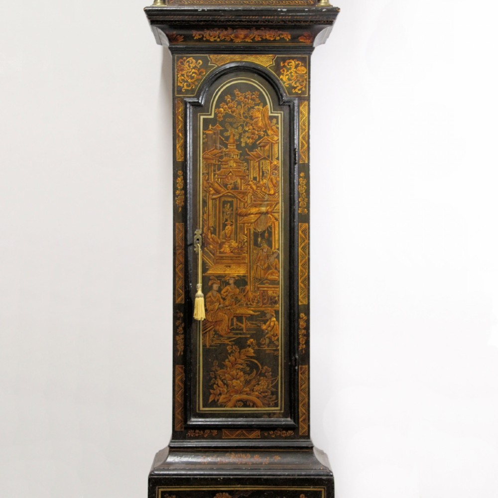 A tall early 18th-century dark green longcase clock decorated with gold Chinoiserie lacquer patterns and an arched brass dial. View VI