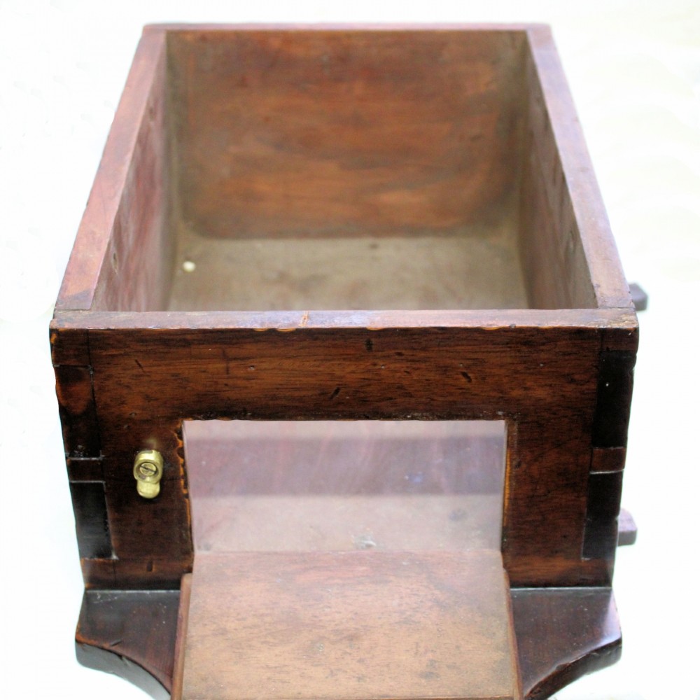 A late 18th-century Georgian mahogany wall clock featuring a circular cream painted dial with Roman numerals, a brass bezel, and a salt-box wooden case. View IX