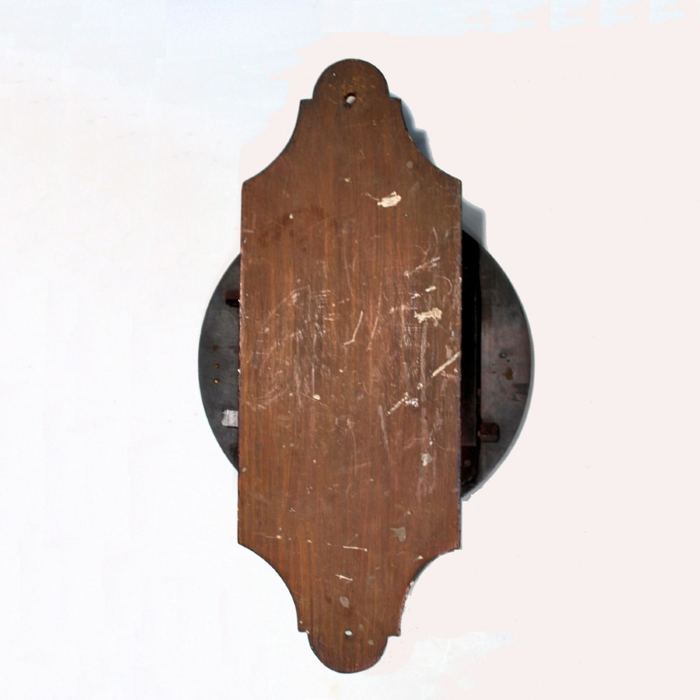 A late 18th-century Georgian mahogany wall clock featuring a circular cream painted dial with Roman numerals, a brass bezel, and a salt-box wooden case. View X