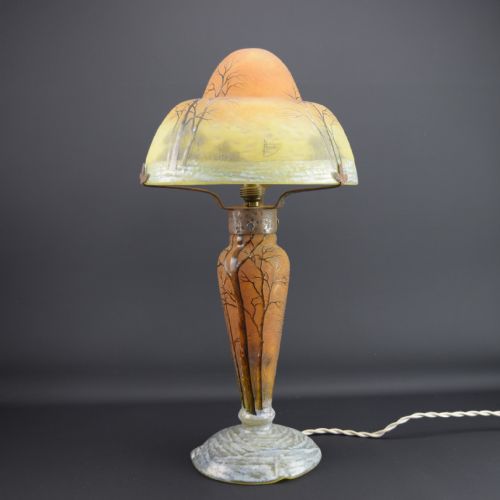 fig 1. An Art Nouveau Daum enamelled cameo glass table lamp featuring a frosted orange and yellow winter tree landscape.