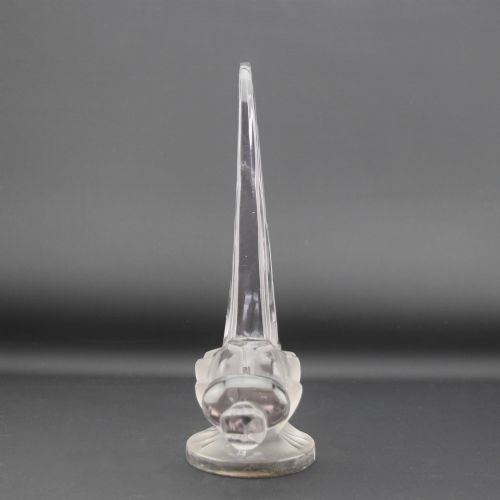 fig 1. An Art Deco clear and frosted glass car mascot sculpted in the form of a stylised dragonfly with upright wings resting on a circular base.