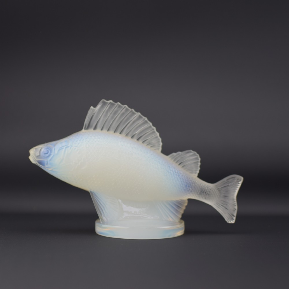 An Art Deco opalescent glass car mascot by Rene Lalique depicting a perch fish on a circular base.