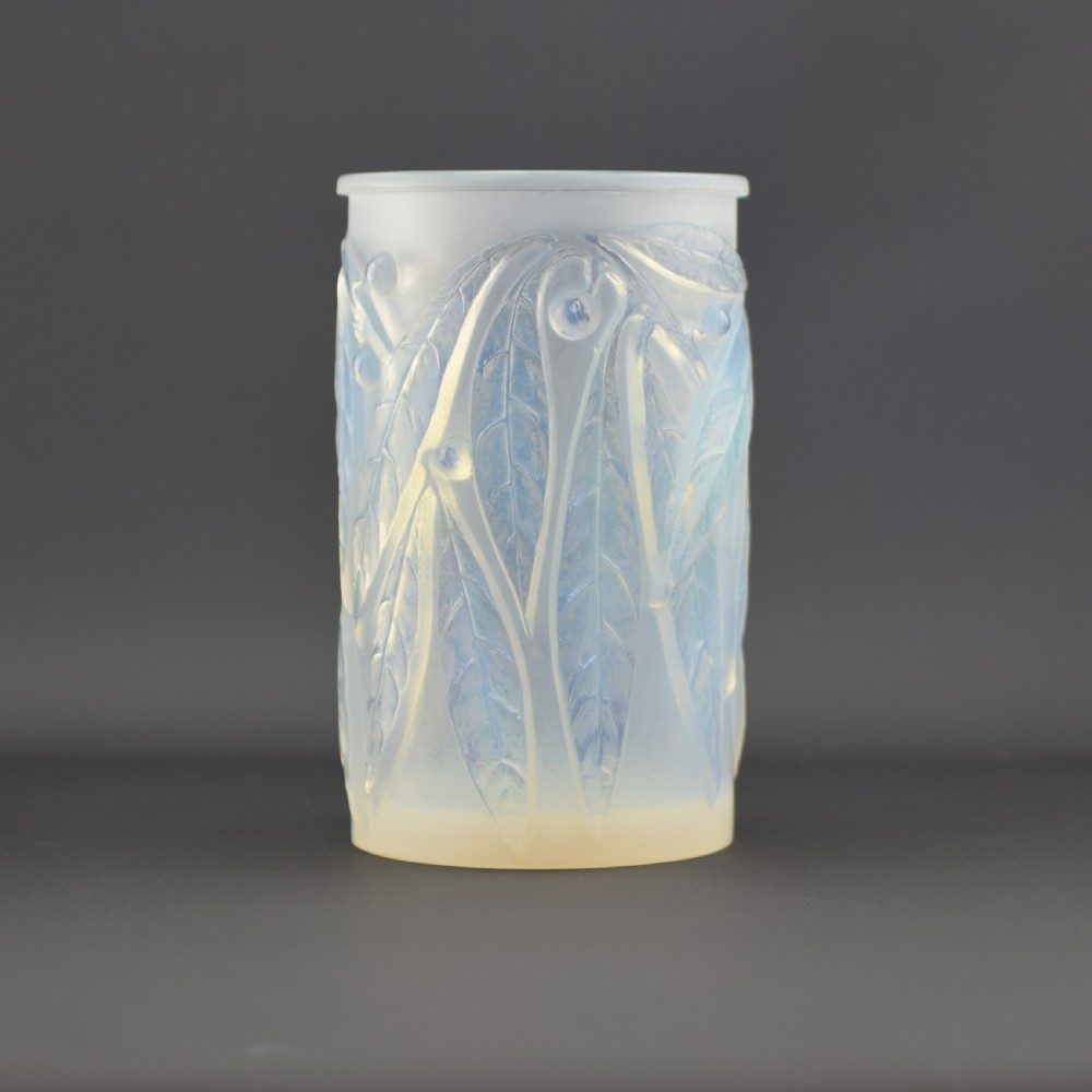 A cylindrical Art Deco opalescent glass vase decorated with relief-moulded laurel leaves and berries.
