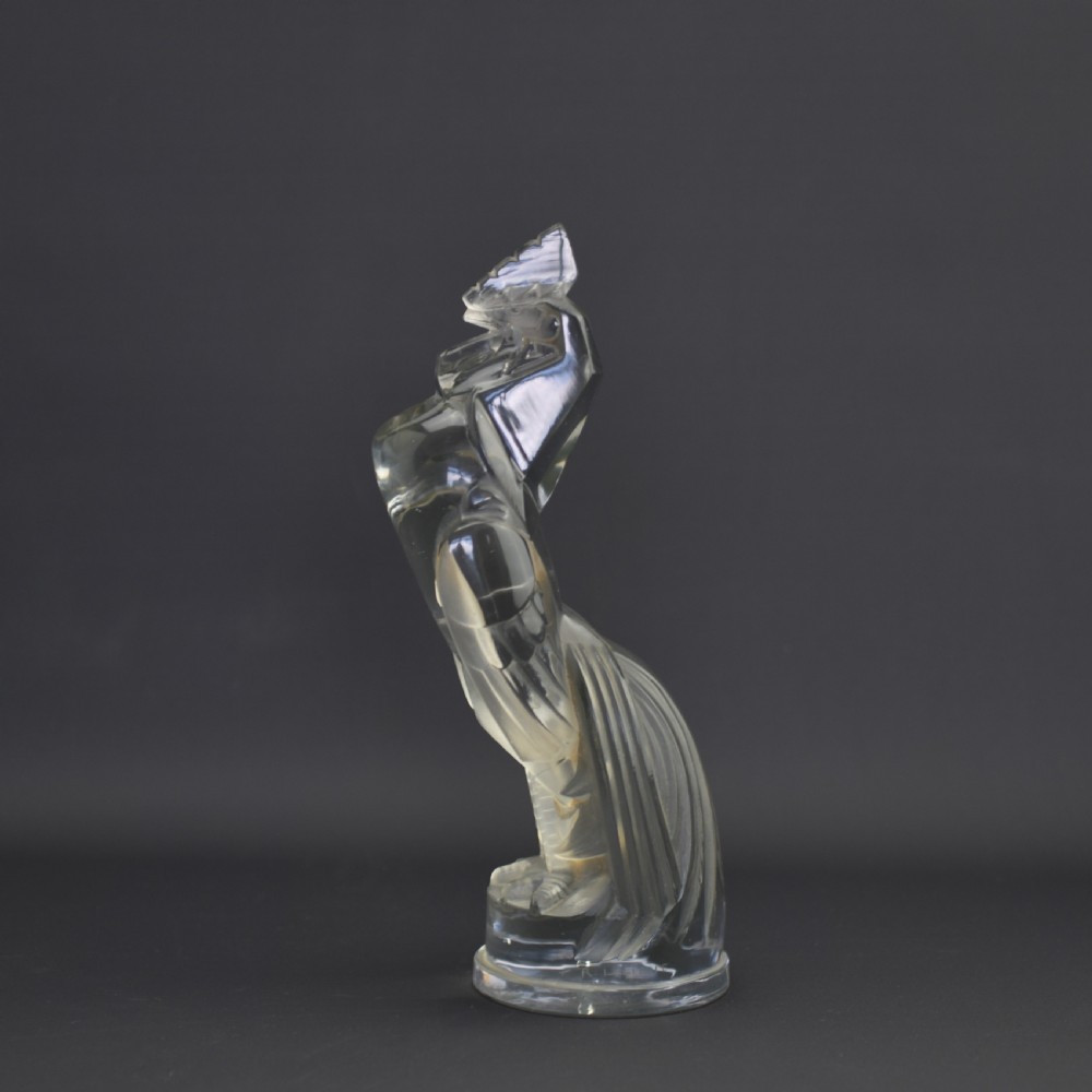 An Art Deco press-moulded clear glass car mascot designed in the form of a stylised standing cockerel.