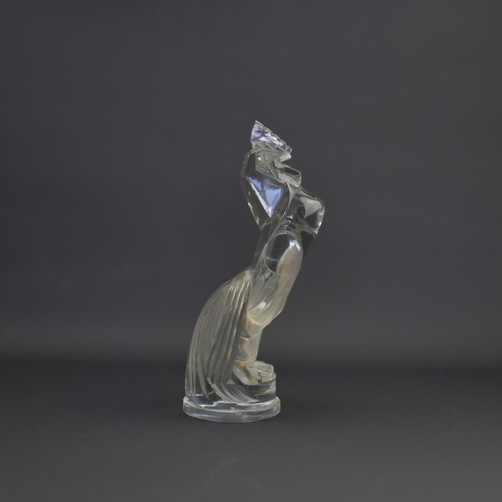An Art Deco press-moulded clear glass car mascot designed in the form of a stylised standing cockerel. View V