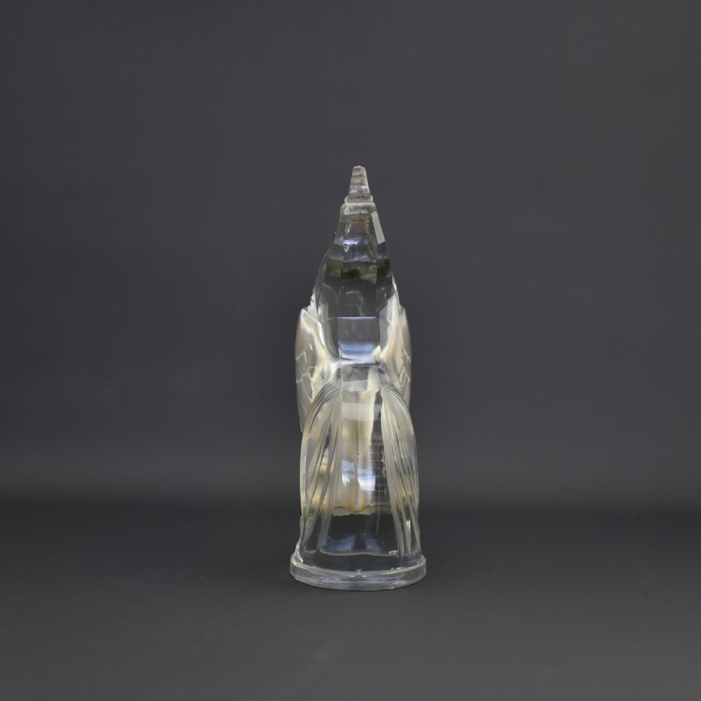 An Art Deco press-moulded clear glass car mascot designed in the form of a stylised standing cockerel. View VI