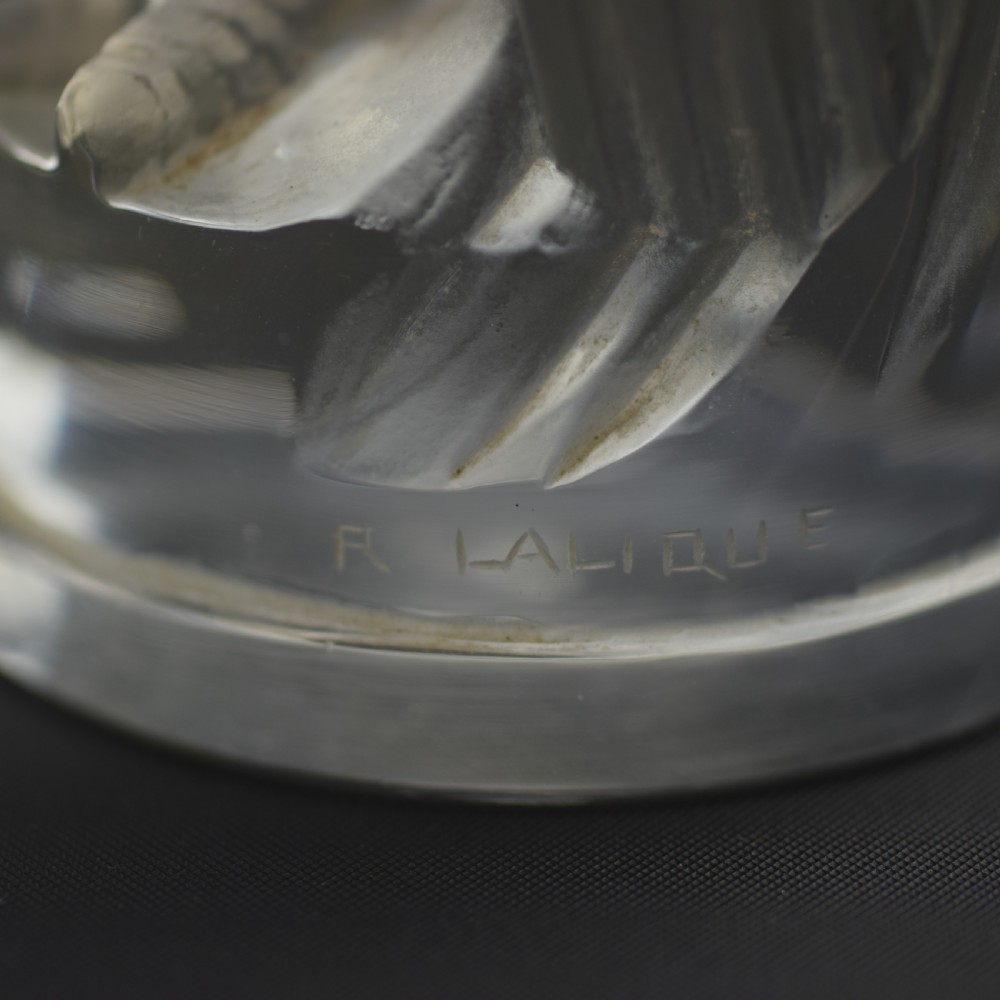 An Art Deco press-moulded clear glass car mascot designed in the form of a stylised standing cockerel. View VII