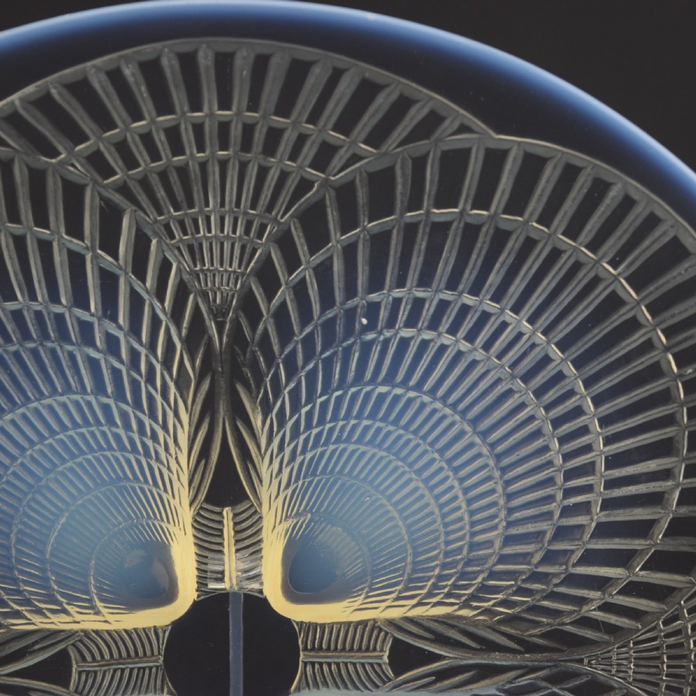 A circular Art Deco opalescent glass plate featuring a relief-moulded four-shell Coquilles design with milky blue tones. View II