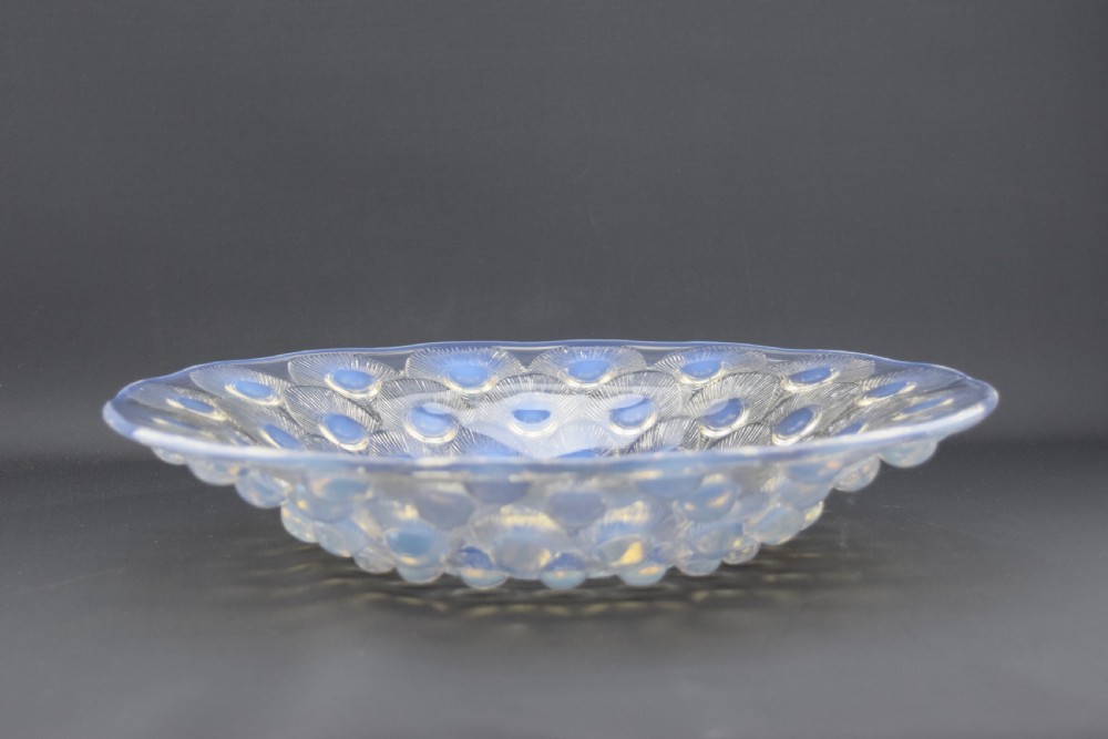 A circular Art Deco opalescent blue glass coupe dish moulded with concentric peacock feather motifs featuring prominent circular cabochons. View III