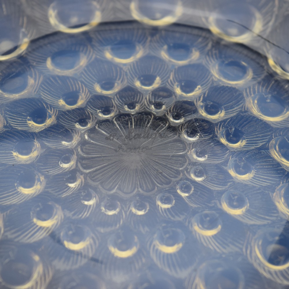 A circular Art Deco opalescent blue glass coupe dish moulded with concentric peacock feather motifs featuring prominent circular cabochons. View IV