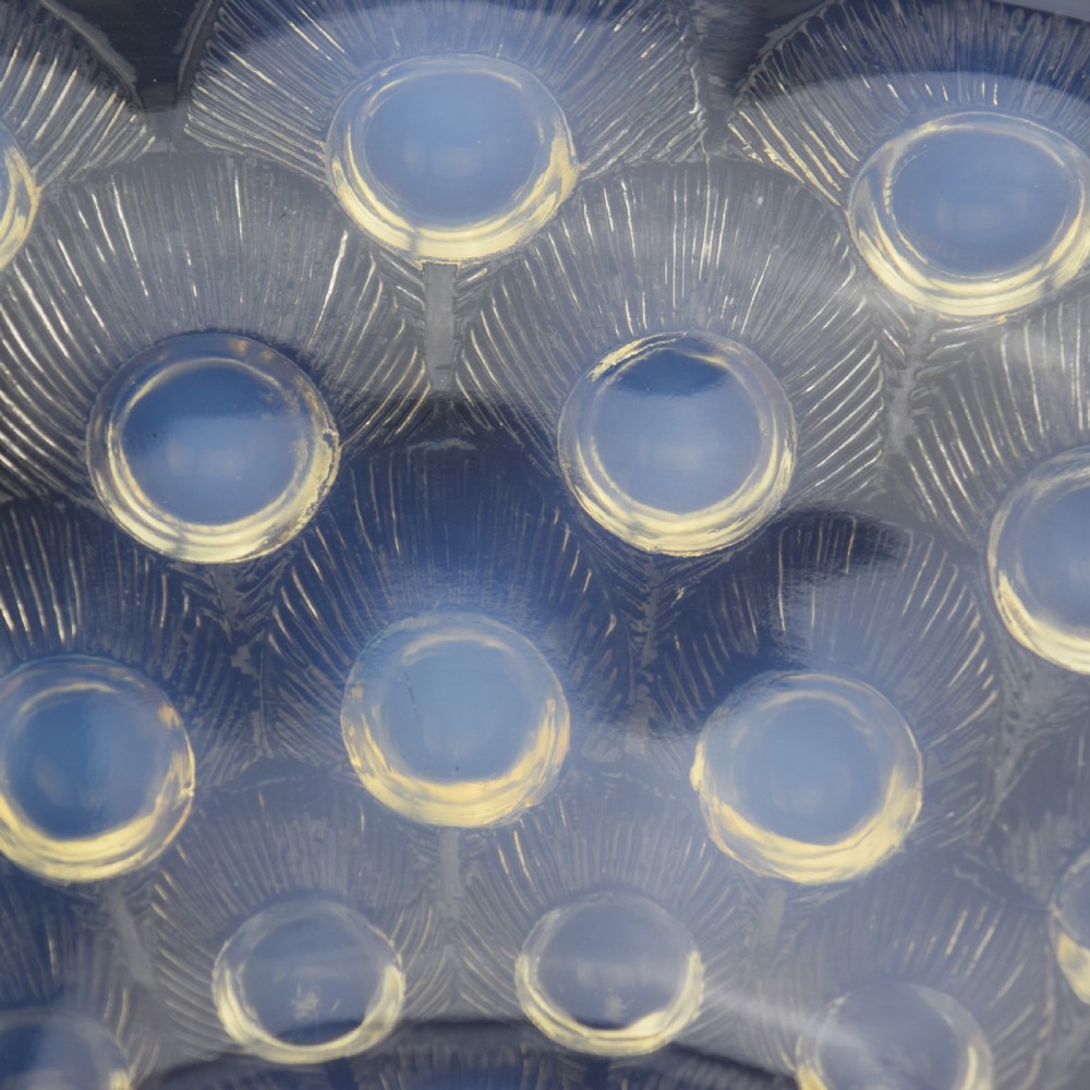 A circular Art Deco opalescent blue glass coupe dish moulded with concentric peacock feather motifs featuring prominent circular cabochons. View V
