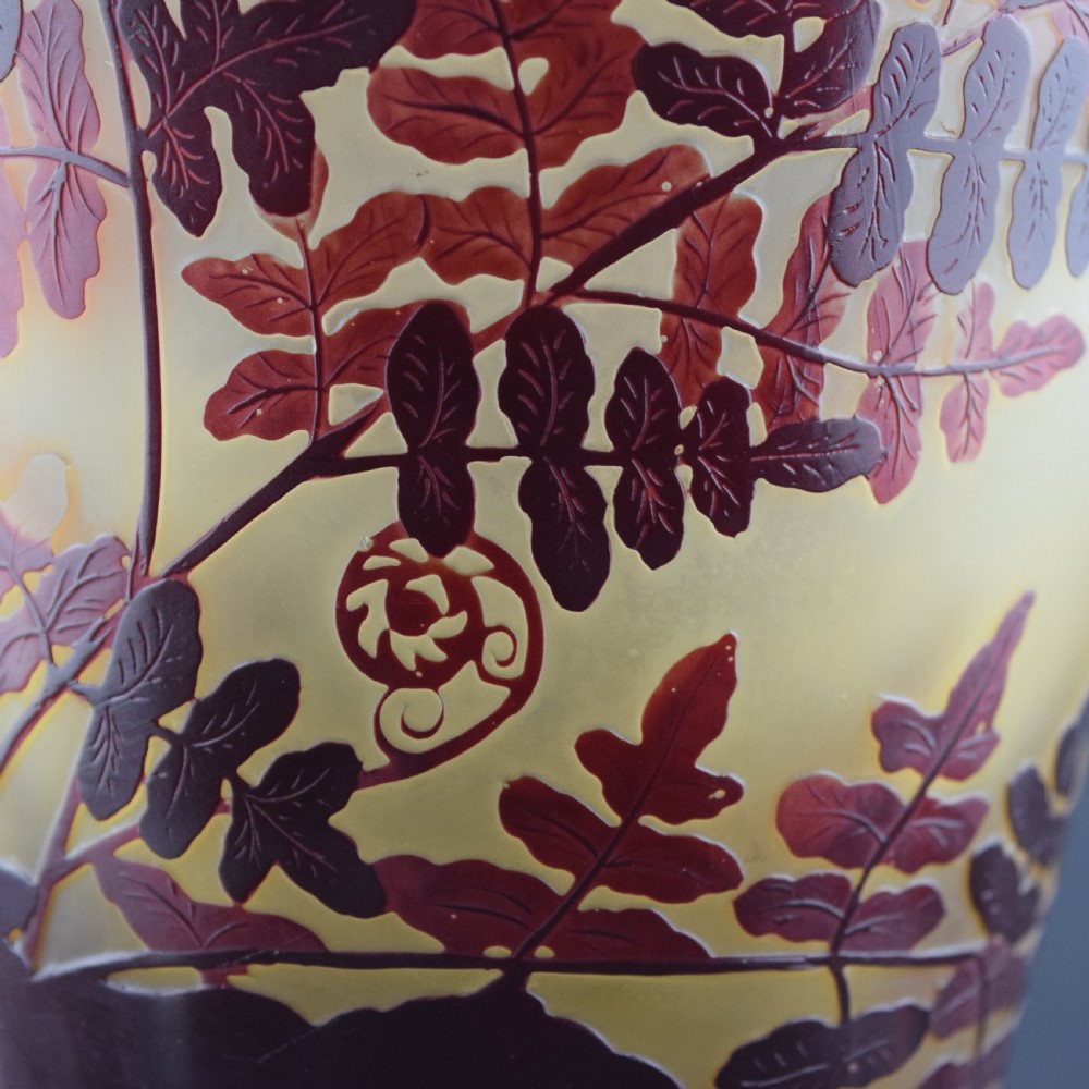An Art Nouveau cameo glass vase featuring frosted yellow glass acid-etched with dark burgundy fern leaf motifs. View IX