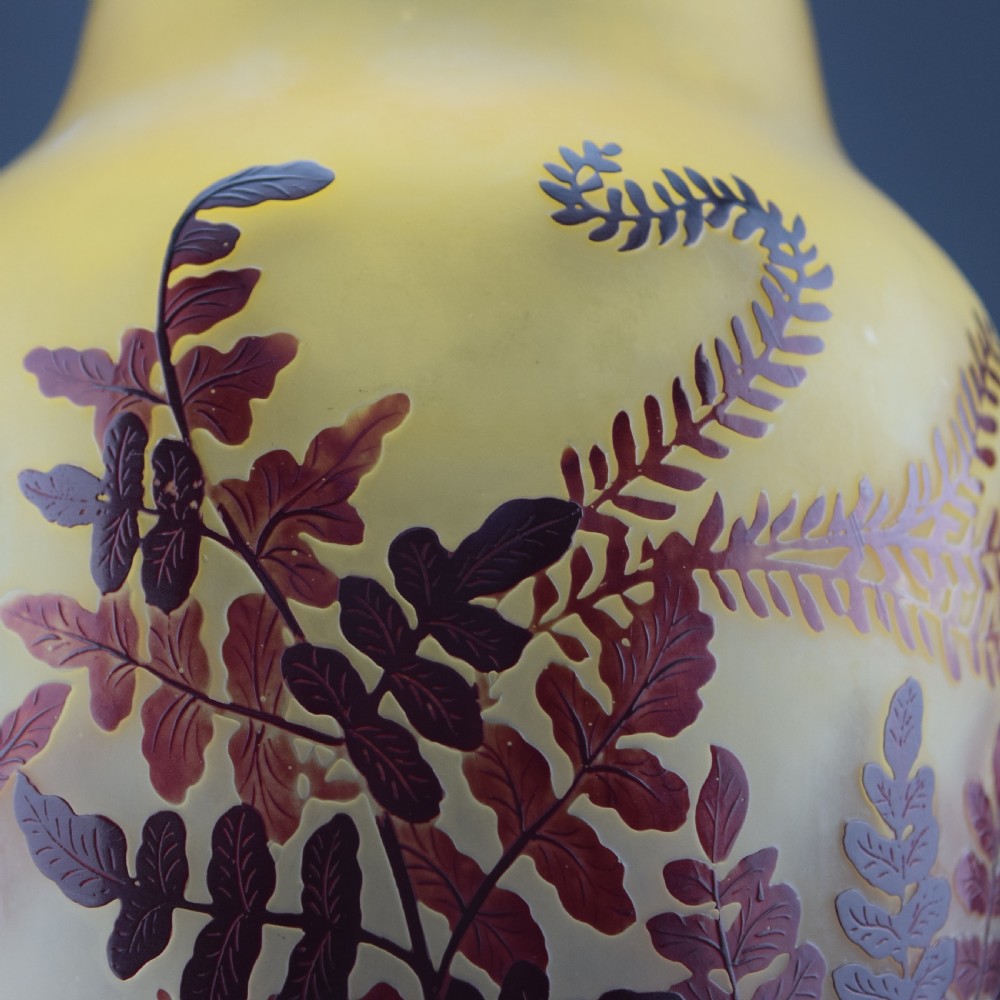 An Art Nouveau cameo glass vase featuring frosted yellow glass acid-etched with dark burgundy fern leaf motifs. View X