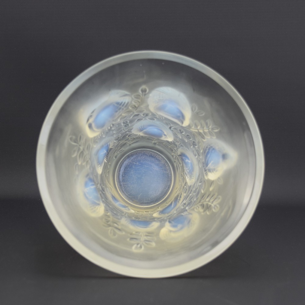 An Art Deco opalescent glass vase with a flared rim featuring moulded high-relief motifs of birds amongst leaves. View V