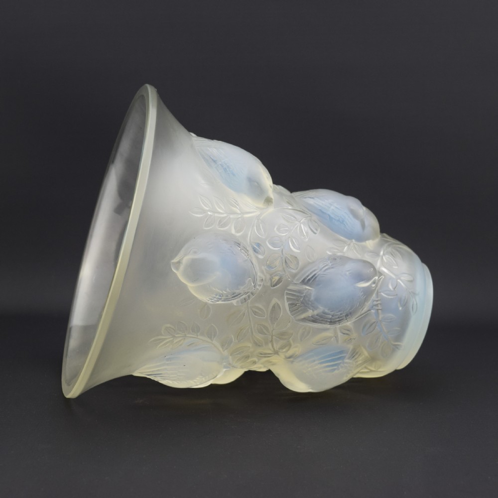An Art Deco opalescent glass vase with a flared rim featuring moulded high-relief motifs of birds amongst leaves. View VI