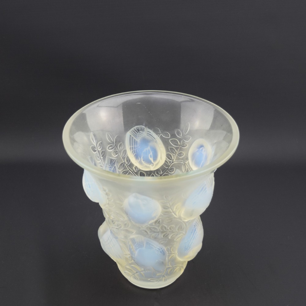 An Art Deco opalescent glass vase with a flared rim featuring moulded high-relief motifs of birds amongst leaves. View VII