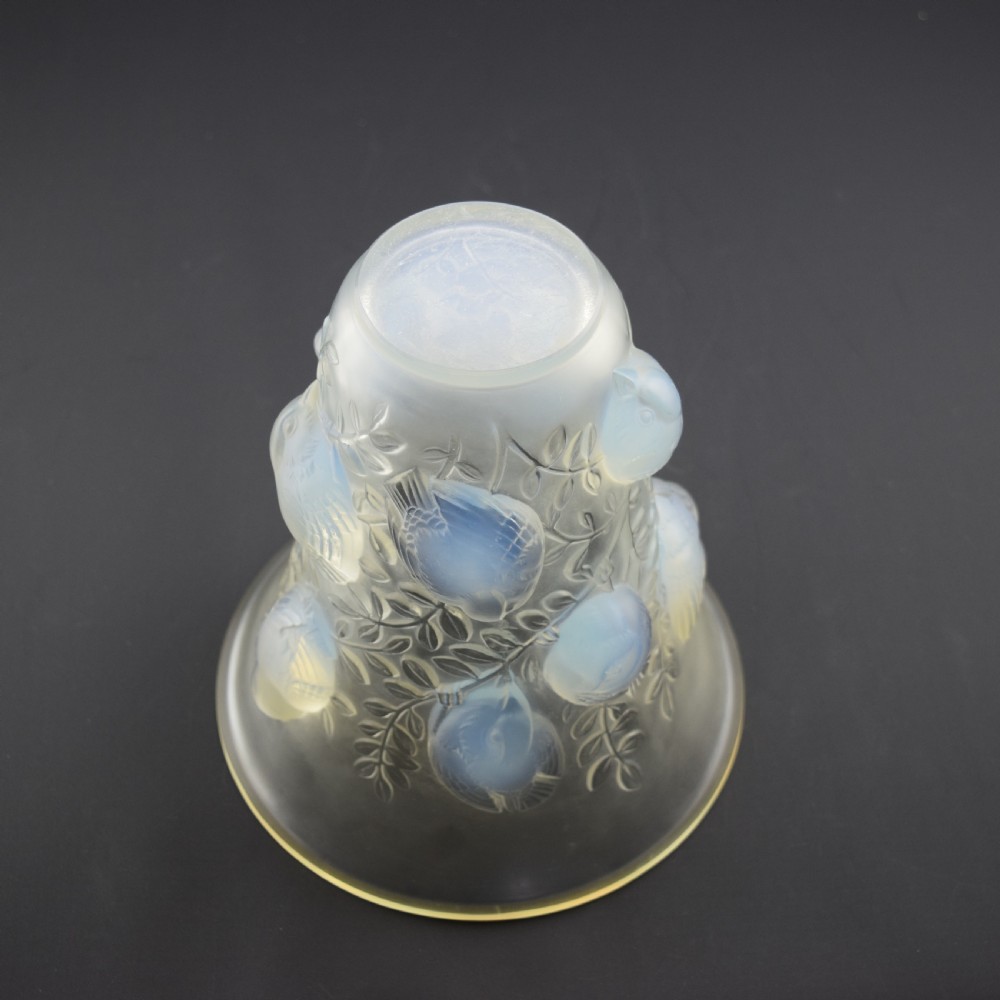 An Art Deco opalescent glass vase with a flared rim featuring moulded high-relief motifs of birds amongst leaves. View VIII