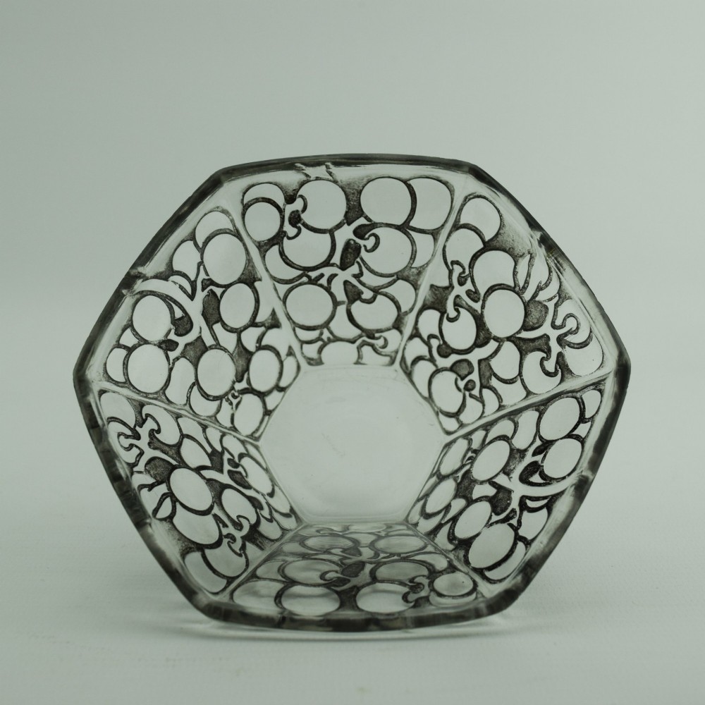 A hexagonal Art Deco clear glass bowl featuring a moulded grape pattern with dark patinated recesses. View II