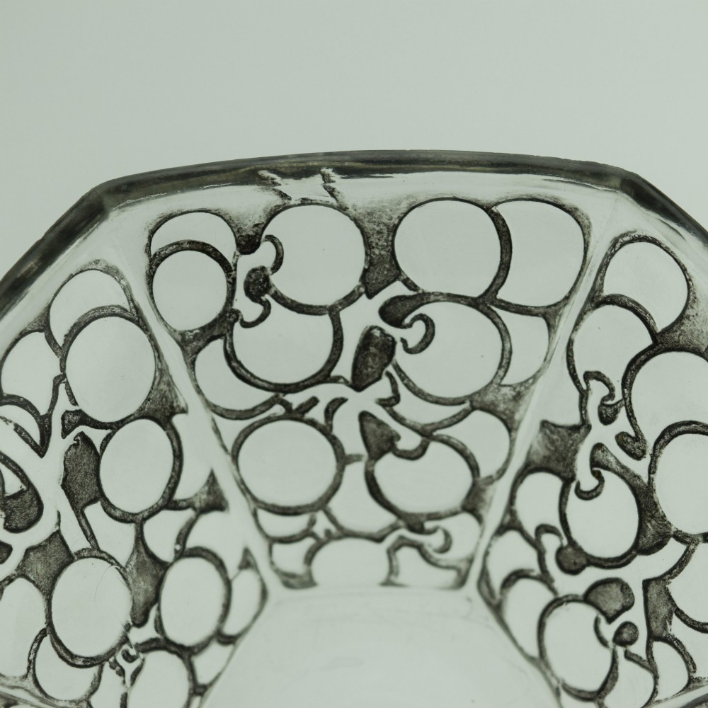 A hexagonal Art Deco clear glass bowl featuring a moulded grape pattern with dark patinated recesses. View III