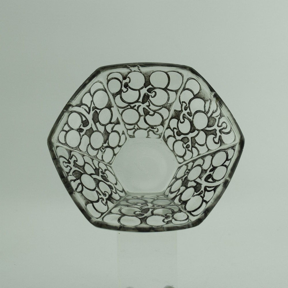 A hexagonal Art Deco clear glass bowl featuring a moulded grape pattern with dark patinated recesses. View V