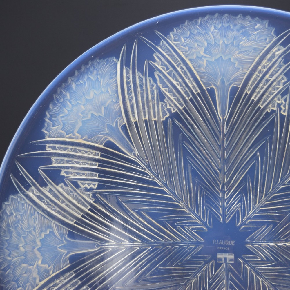 A circular Art Deco opalescent glass shallow bowl featuring a molded floral carnation design radiating from a central signature. View IV